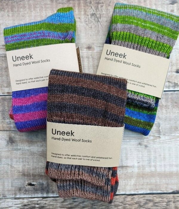 3 pairs of folded stripey socks, each wrapped in a cardboard band